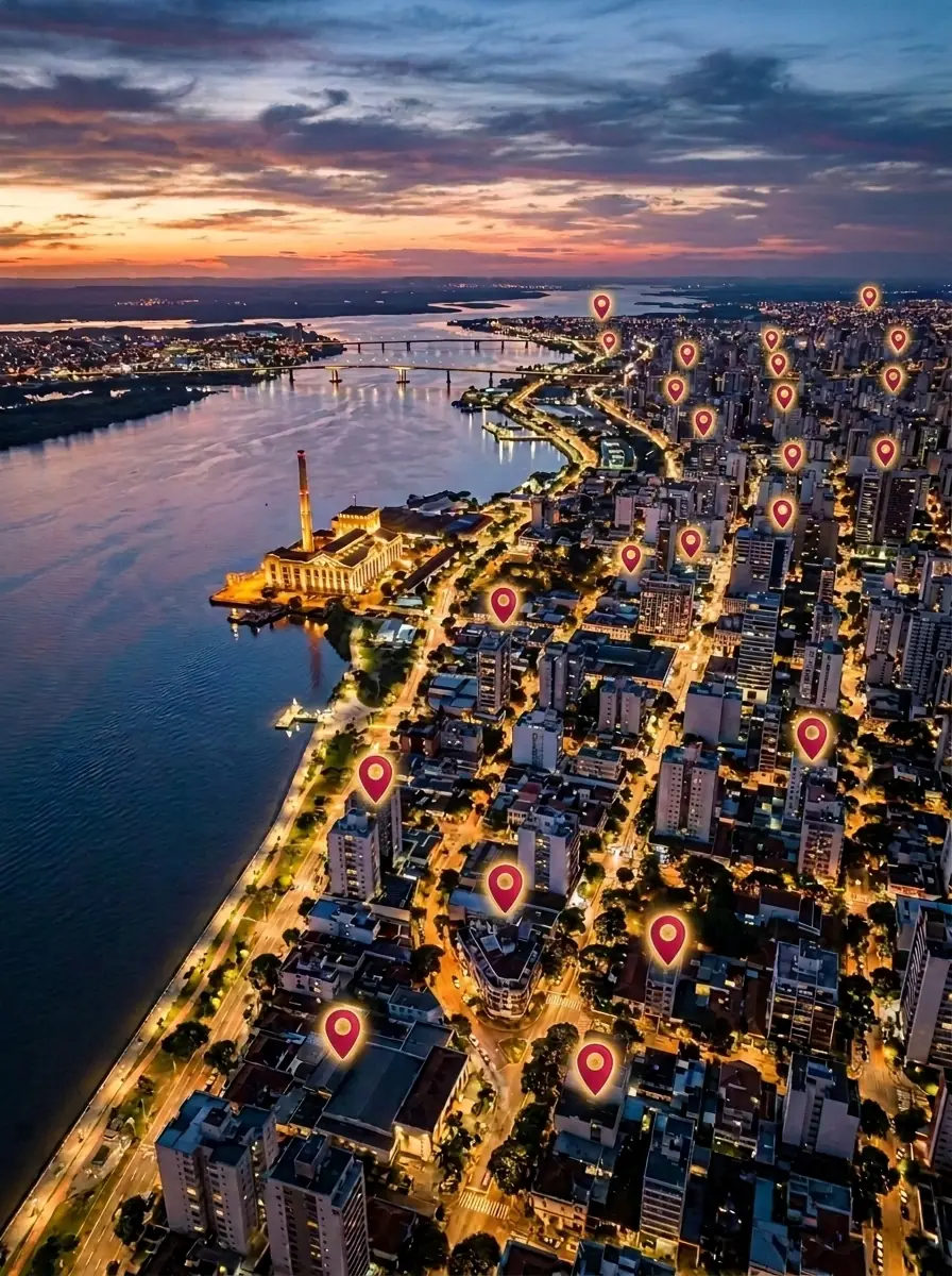 Vista aérea de Porto Alegre ao anoitecer com dezenas de marcadores de busca do Google sobre a cidade